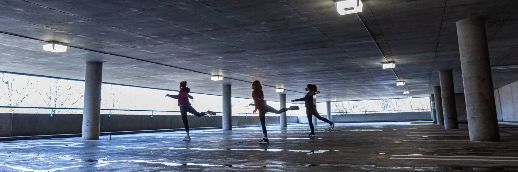 Image of dancers performing in a parking garage