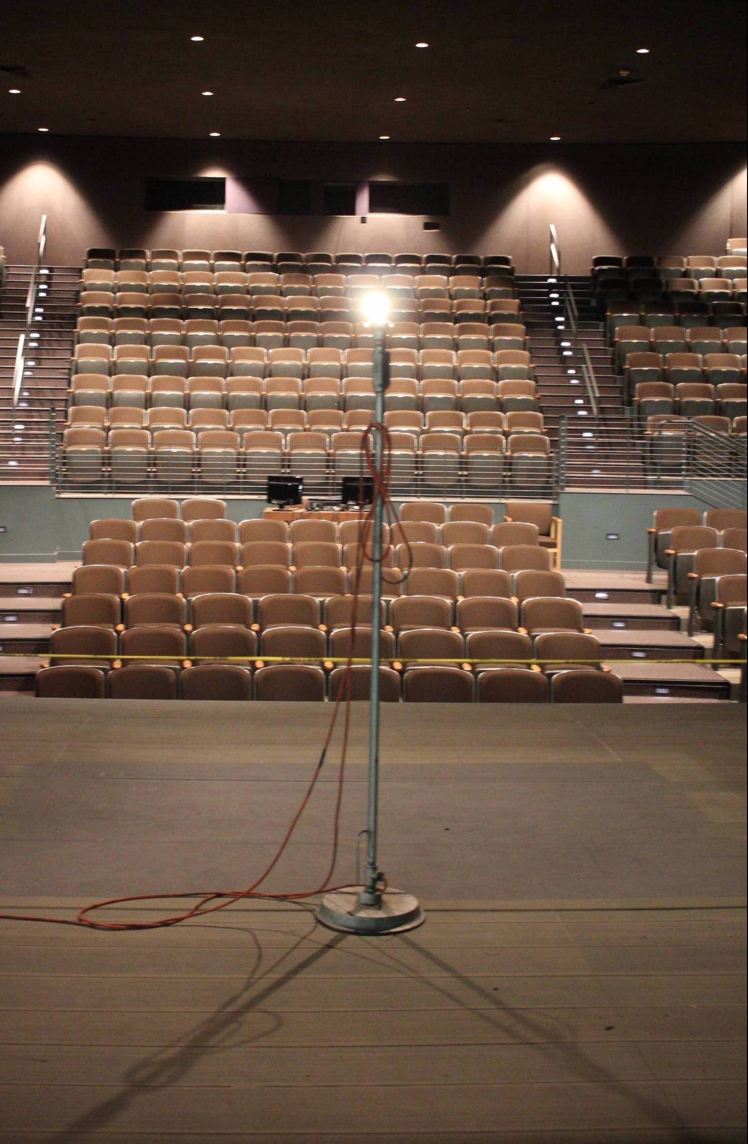 Light pole on stage in the middle of an empty theatre