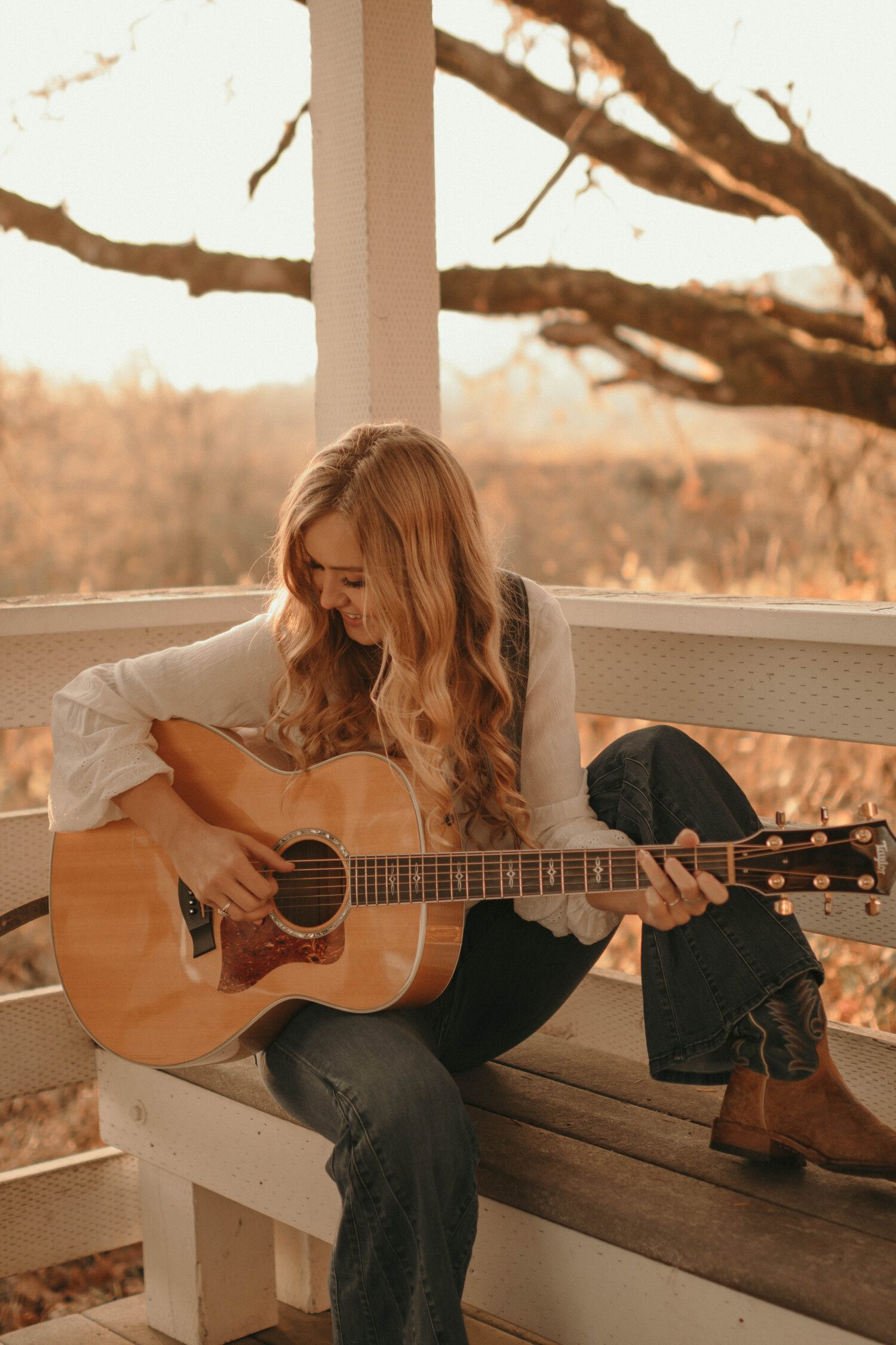 Image of McKayla Marie outside holding a guitar
