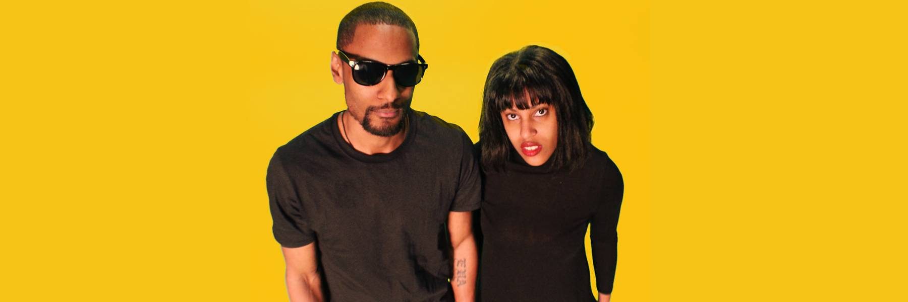 Picture of a man and woman facing the camera; man is on the left with sunglasses on and woman is on the right.