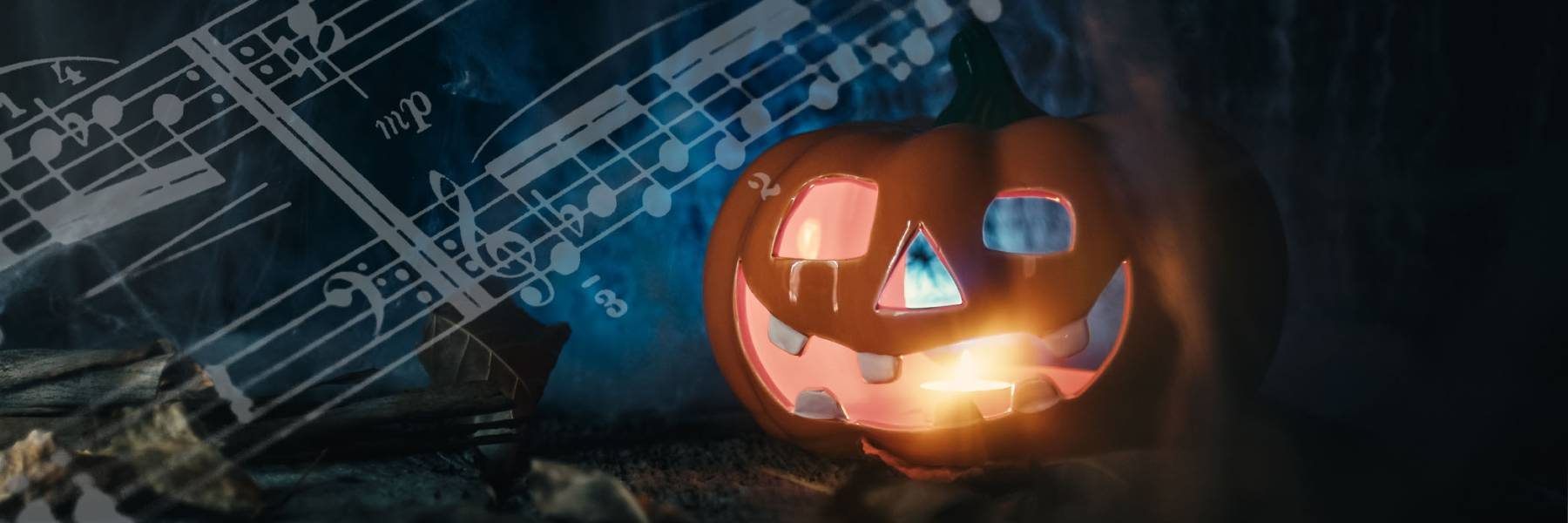A pumpkin carved for Halloween with music notes on the left corner of image